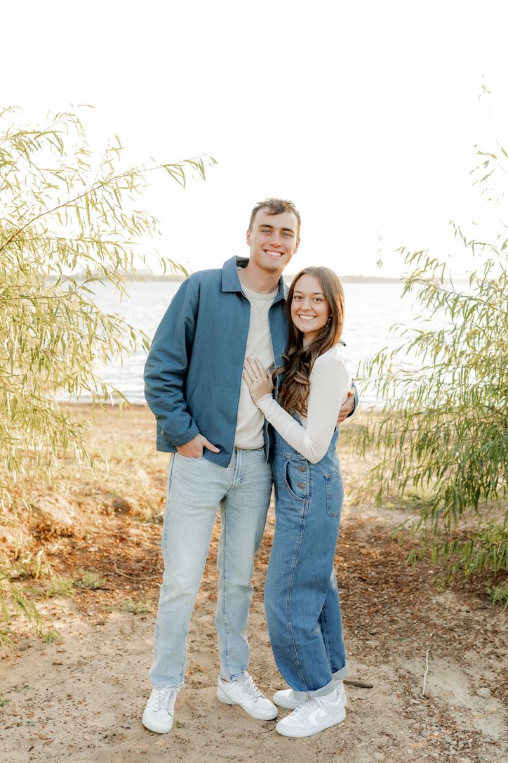 Kenzie and Justin smiling by a lake